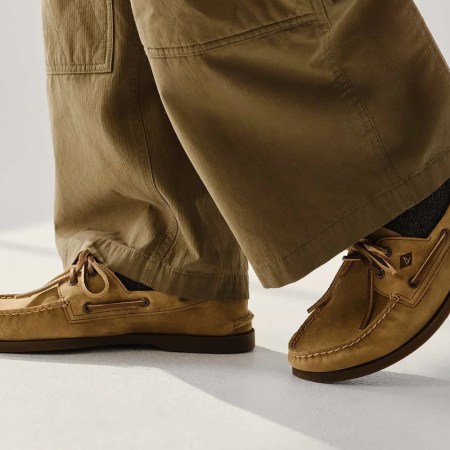 a model in a pair of tan pants and Sperry boat shoes