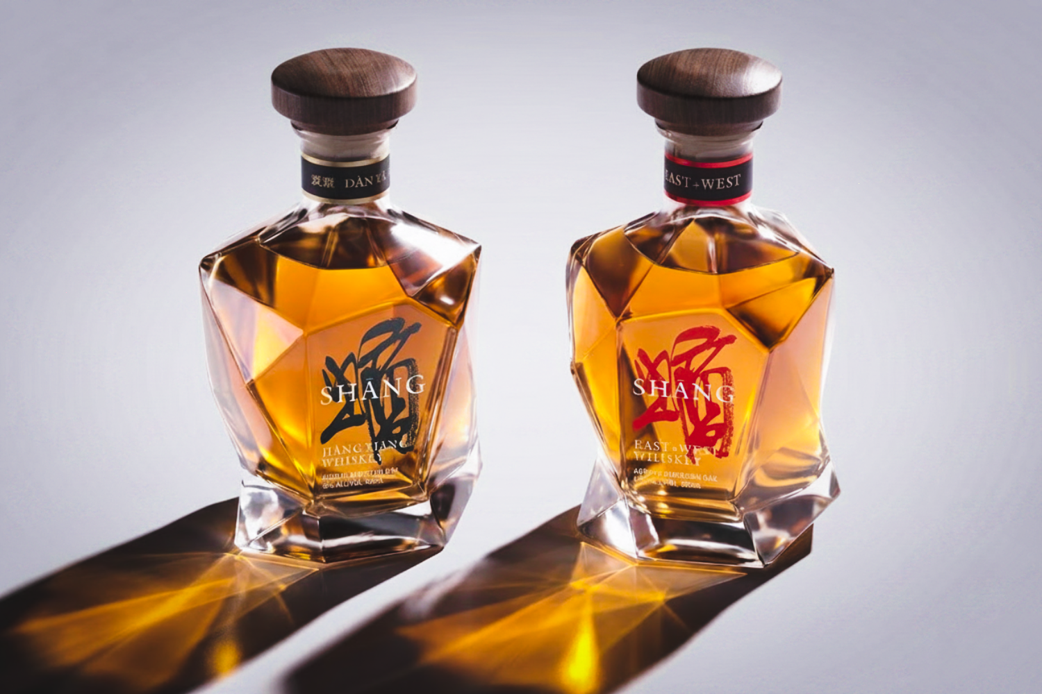 Two bottles of Shang whiskey on a grey background, with shadows