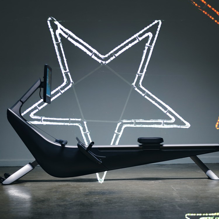 A rowing machine flanked by neon lights in the shape of stars