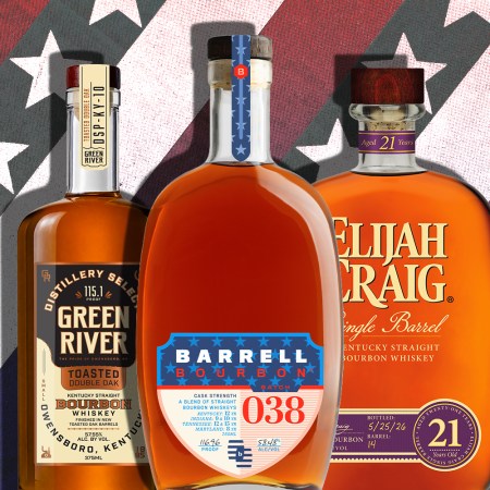 Three whiskey bottles in front of stars and stripes