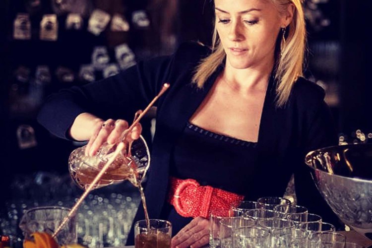 Tales of the Cocktail Executive Director Charlotte Voisey making a drink on a bar