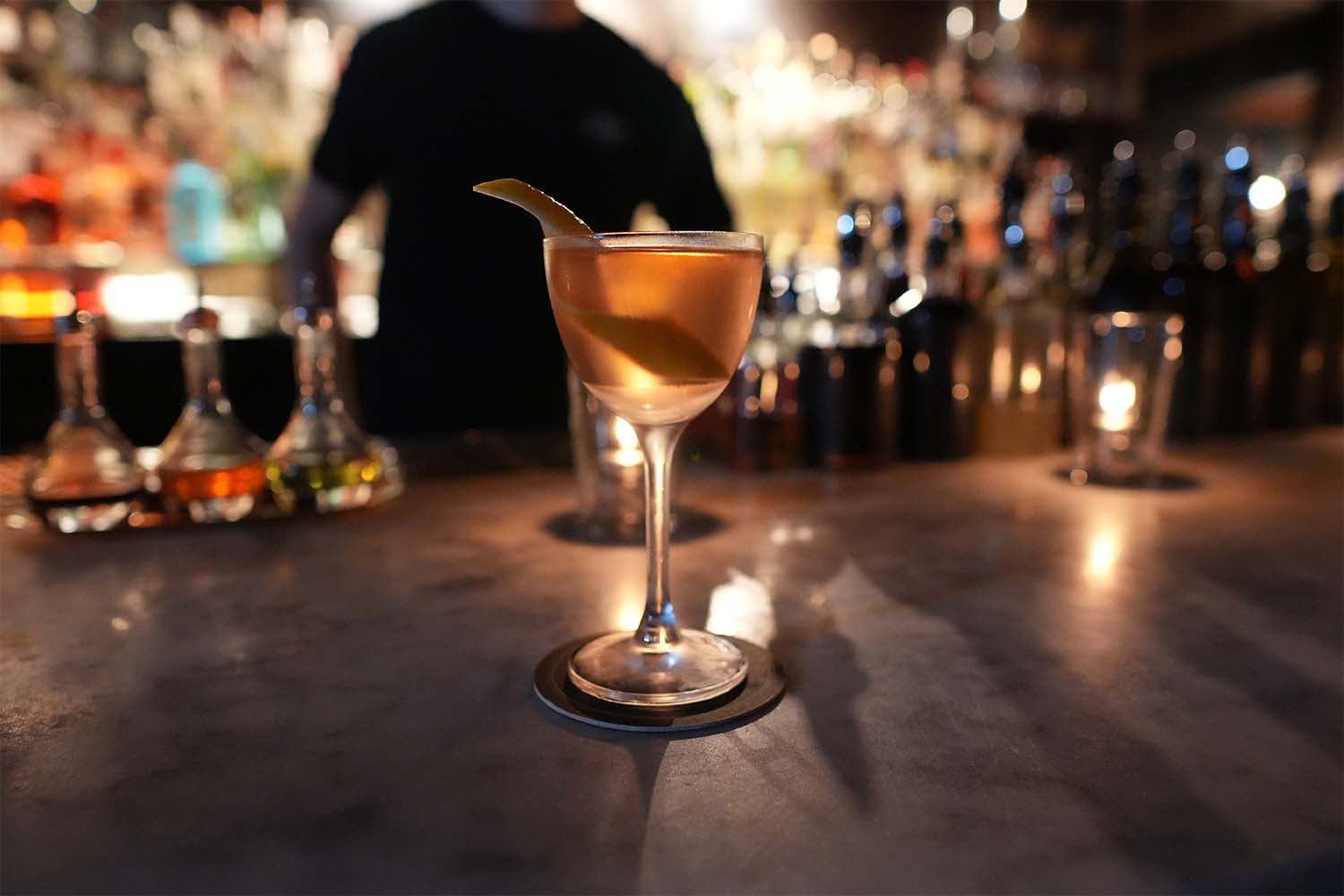 A close-up of a cocktail on the bar top of Death & Co.
