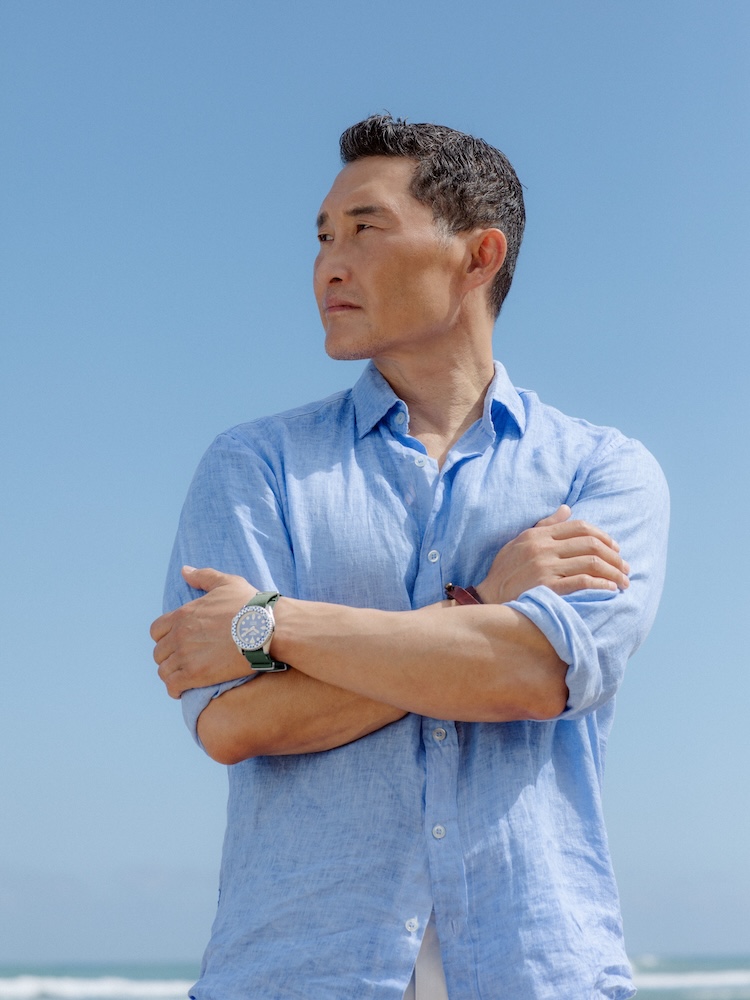 Daniel Kim standing in a blue shirt and Seiko x Rowing Blazer watch looking right.