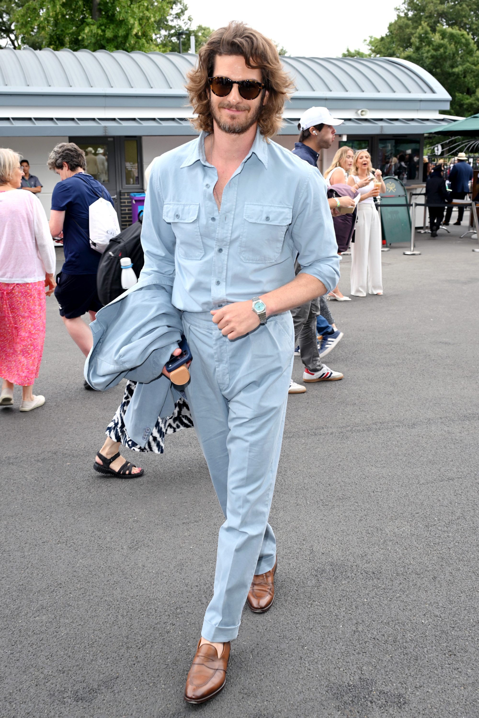 Actor Andrew Garfield wearing a baby blue outfit and watch