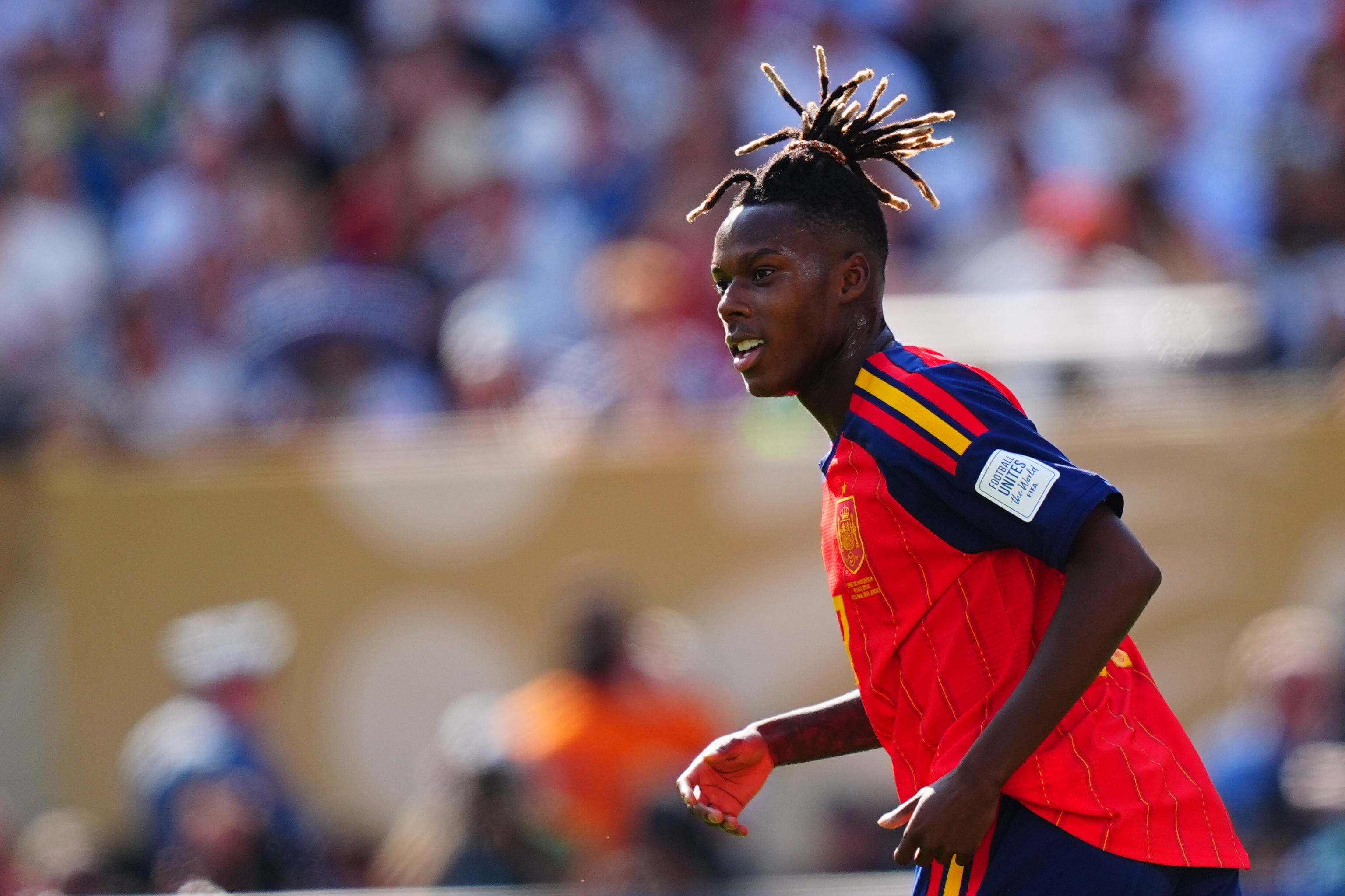 a man in a red jersey playing soccer