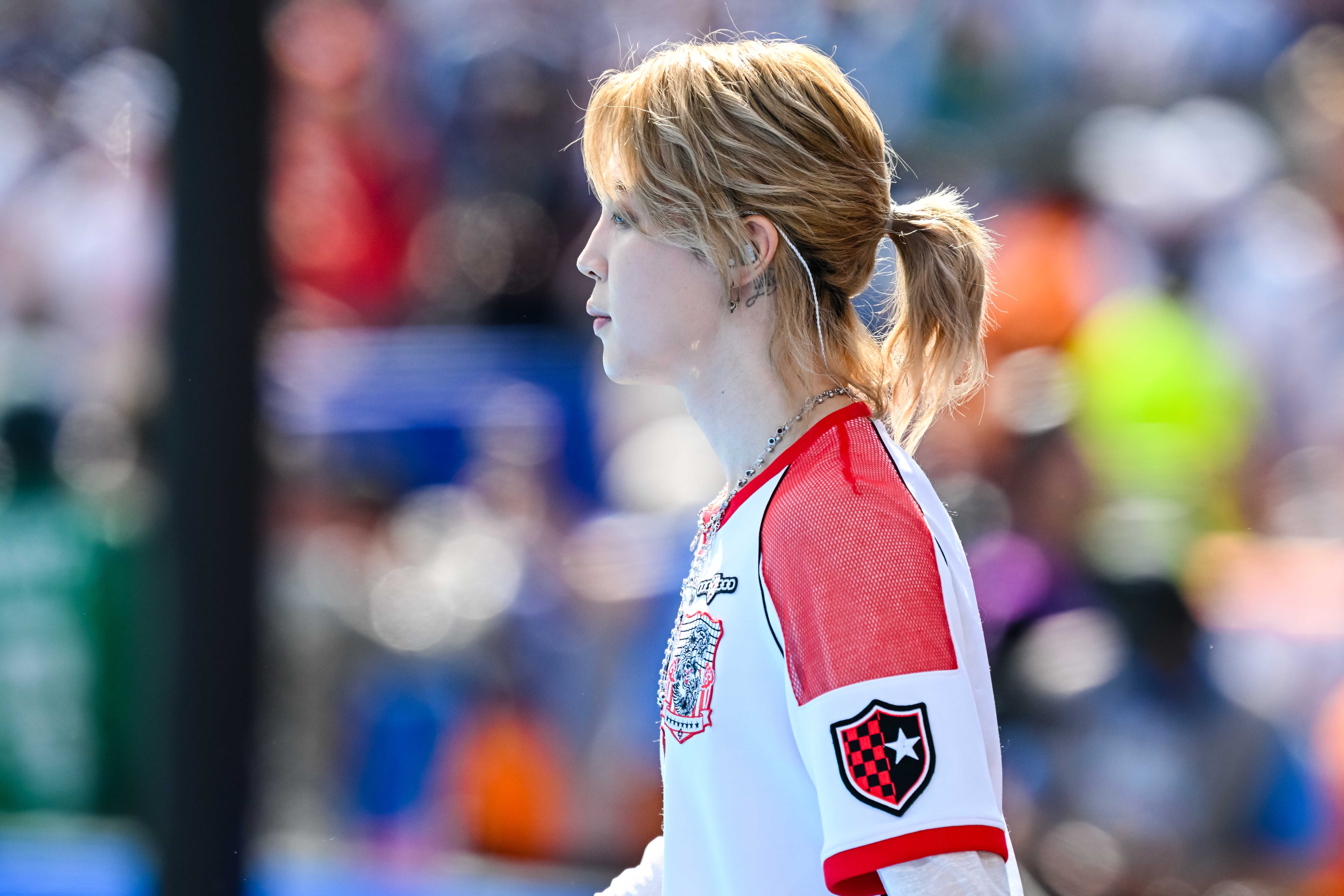 the profile of a man with long blonde hair in the ponytail