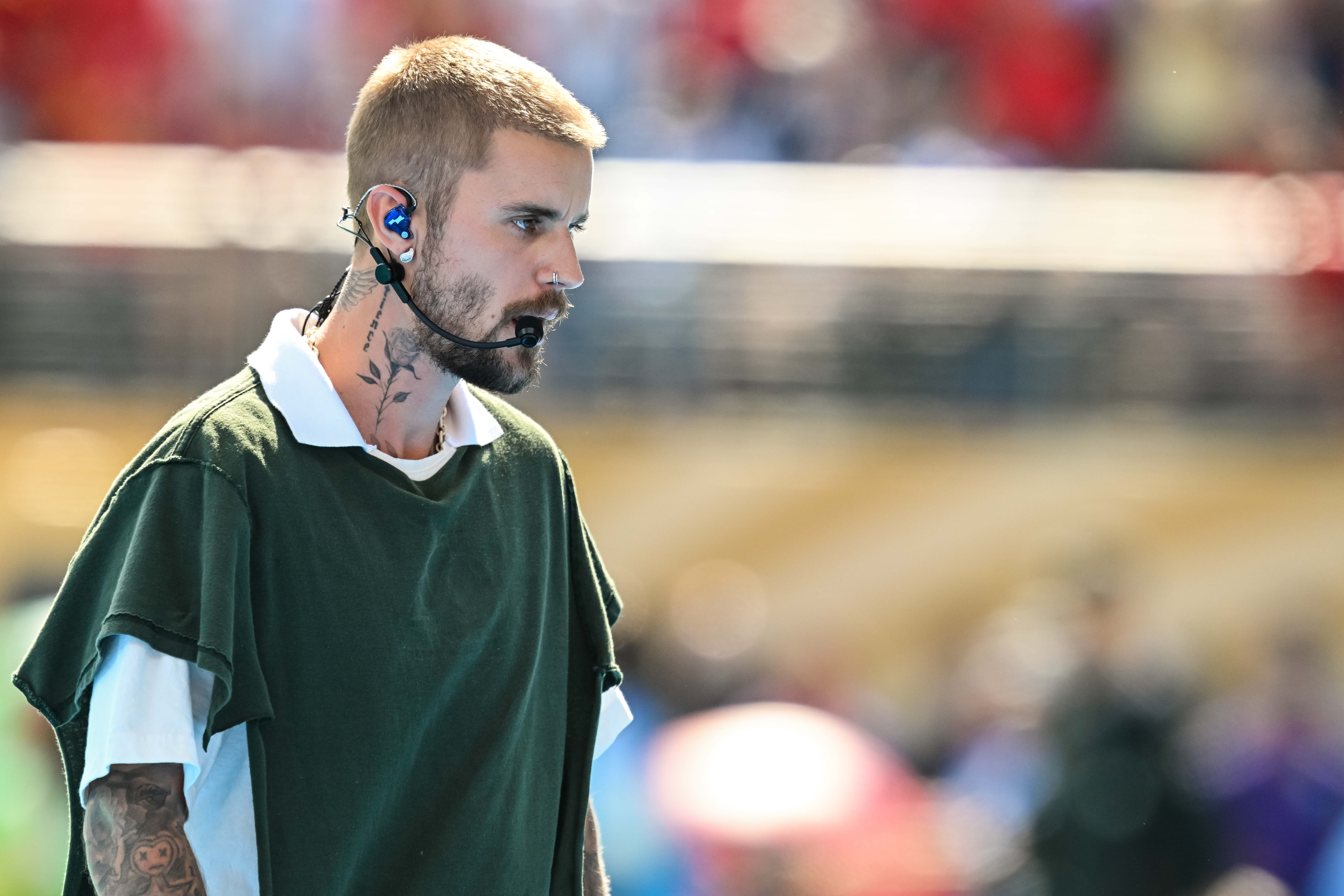 a man with a short hair cut, beard and microphone