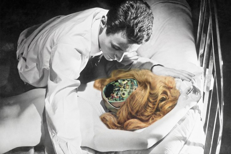 A black and white image of a man leaning over a woman on a bed, but the woman has a robotic head that is in full color