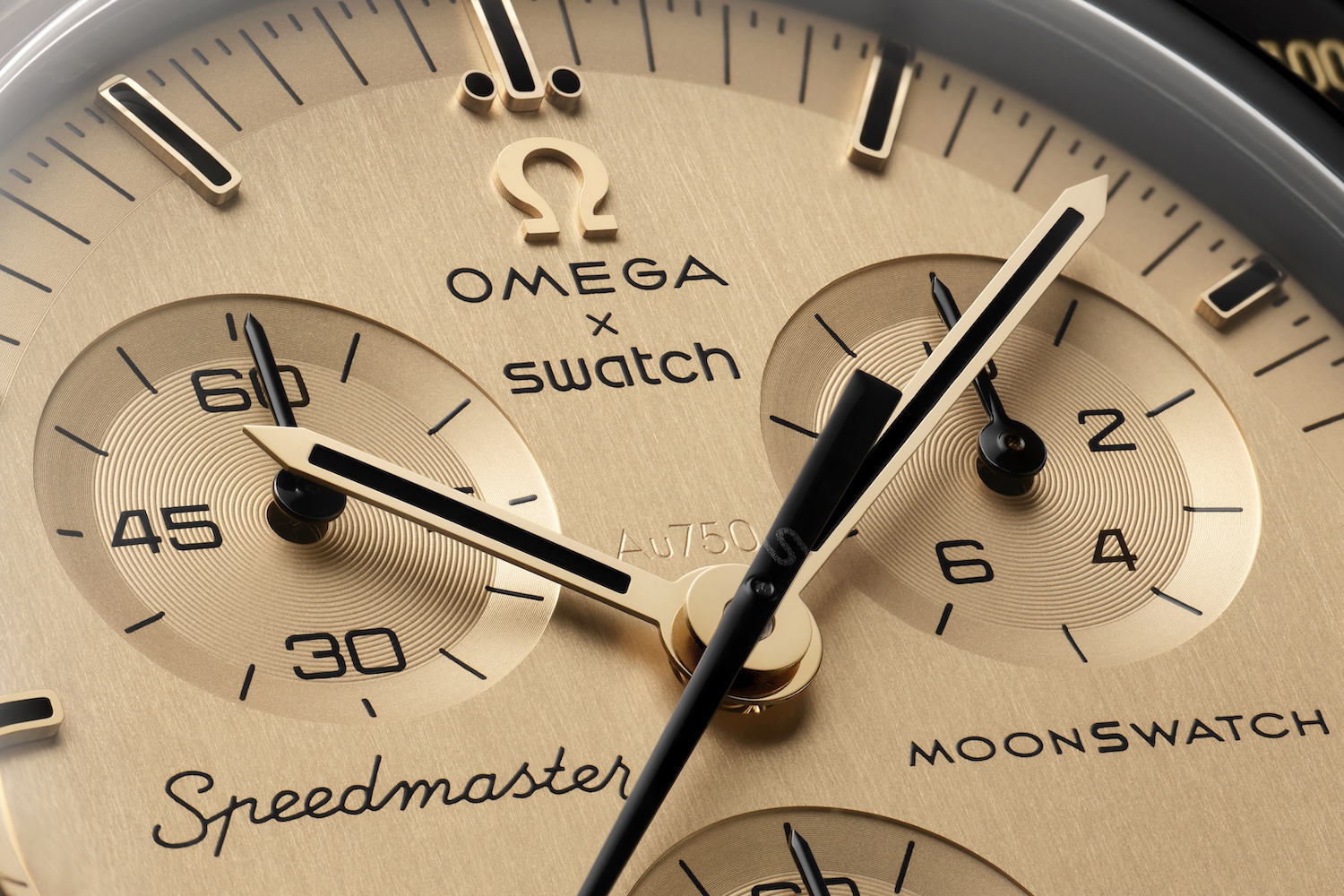 An up-close view of a golden watch face from the Omega x Swatch Moonswatch 1969
