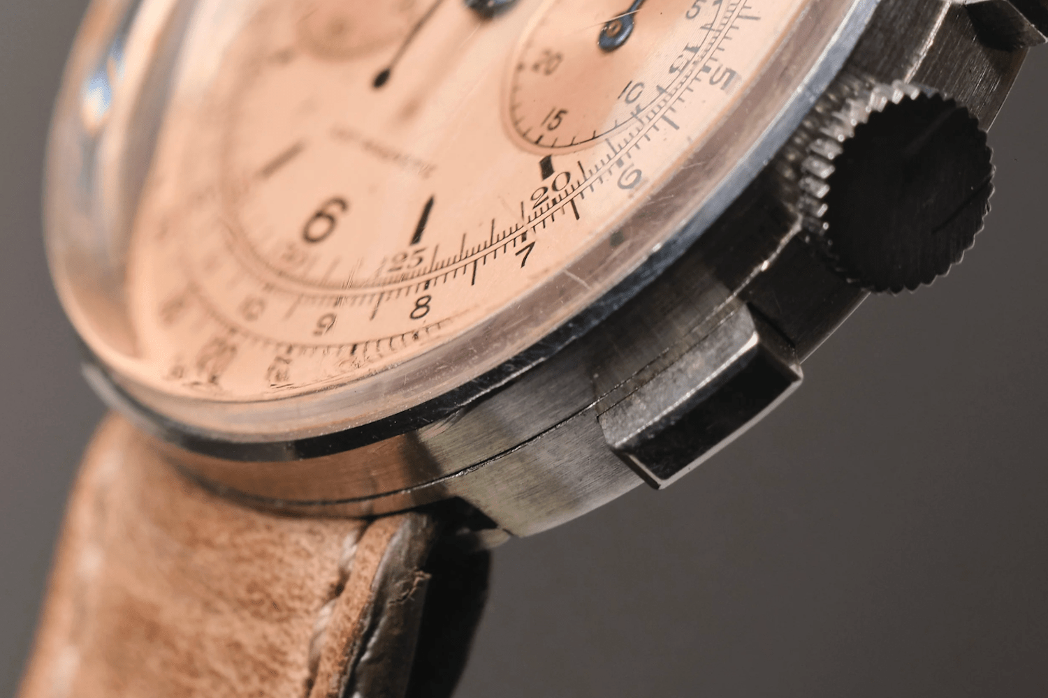 a salmon dial chronograph watch on leather strap