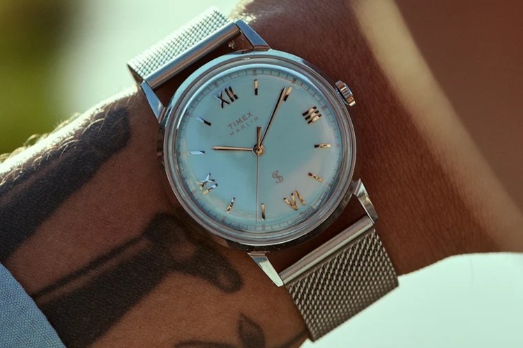 a blue face Timex x Todd Snyder watch on a man's wrist
