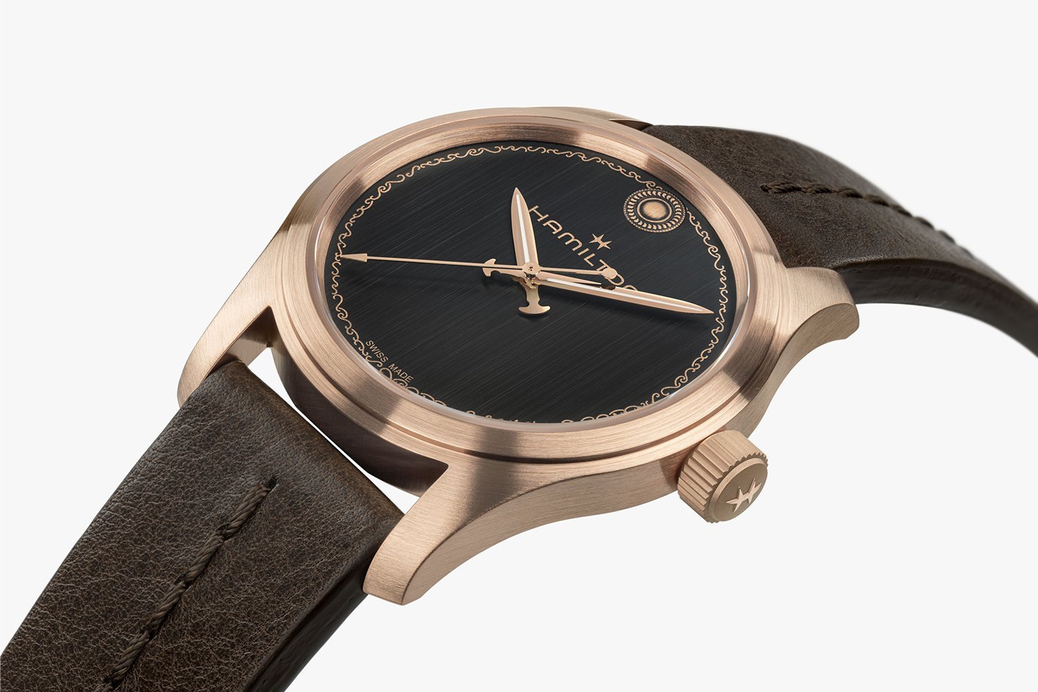 A bronze watch with a brown leather strap and a black dial with the word "Hamilton" emblazoned across the dial
