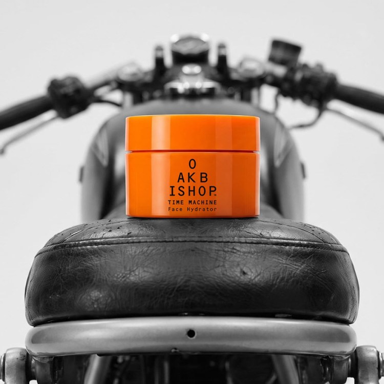 a moisturizer in an orange jar on a motorcylce