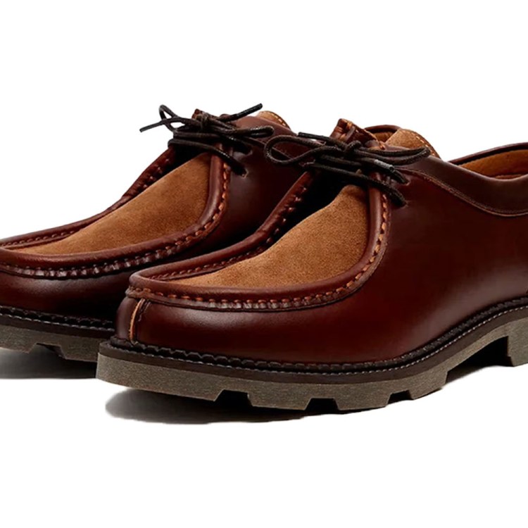 Pair of brown leather moccasin-style shoes with lighter brown suede inserts and dark laces.