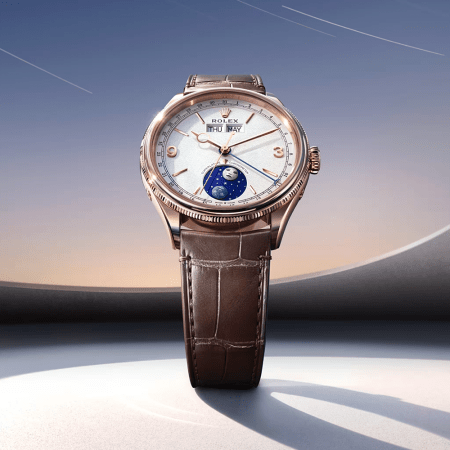 Rose gold Rolex Cellini Moonphase watch with a white dial, brown leather strap, and a moon phase indicator.