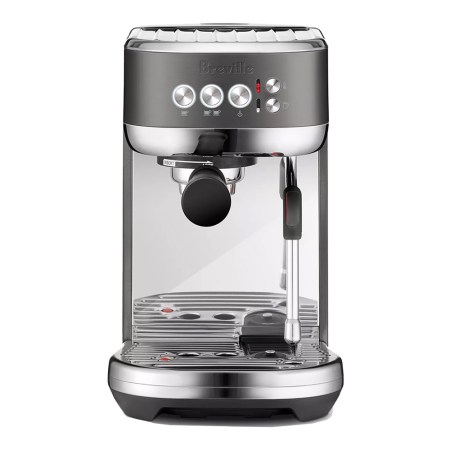A Breville espresso machine with a dark gray top, chrome accents, and a black portafilter.