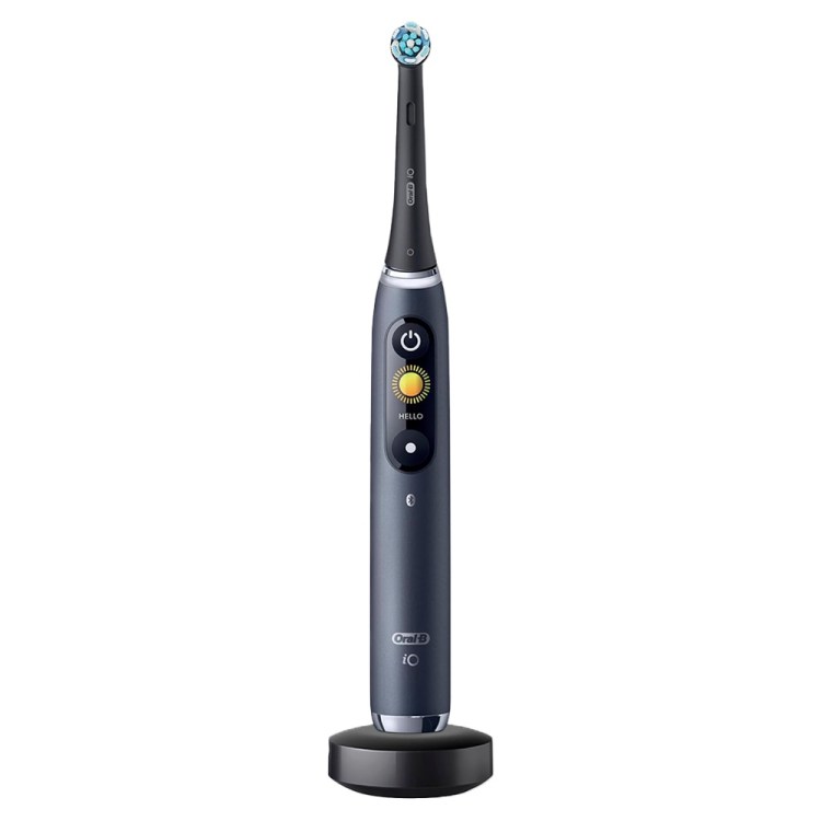 Oral-B iO Series 9 electric toothbrush in black, with a blue-bristled head, on its charging base.